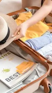 Suitcase with travel essentials for Paris