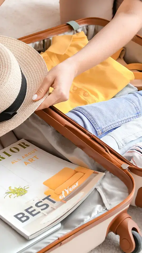 Suitcase with travel essentials for Paris